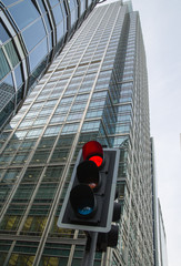 Traffic lights multiple exposure image. Traffic light showing red against of modern office block building. Business and modern life concept.  