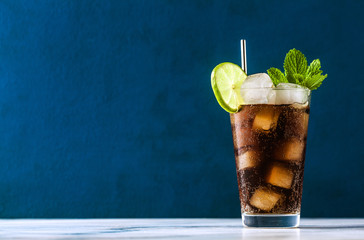 Wall Mural - Coca Coke cocktail in a tall glass cuba libre. refreshing summer drink