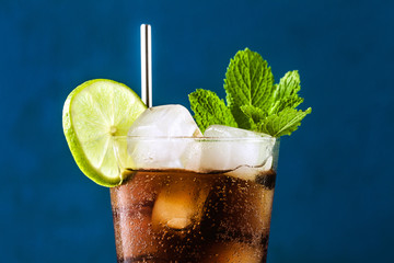 Coca Coke cocktail in a tall glass cuba libre. refreshing summer drink