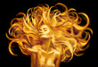 © Subbotina Anna - Golden beauty woman. Sexy model girl with golden makeup and long hair pointing hand over black. Metallic gold glowing skin and fluttering hair