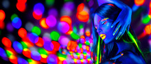 Sexy Girl Dancing In Neon Lights. Fashion Model Woman With Fluorescent Makeup Posing In UV On Bright Background