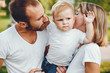 © hetmanstock2 - Family in a summer park. Mother in a white t-shirt. Cute little boy with a dad