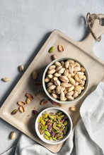 Roasted Pistachio Nuts In Shells With A Bowl Of Kernals.