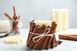 © New Africa - Candle with cinnamon sticks on marble table