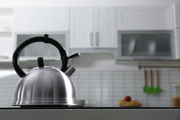 Wall Mural - Modern kettle with whistle on stove in kitchen, space for text