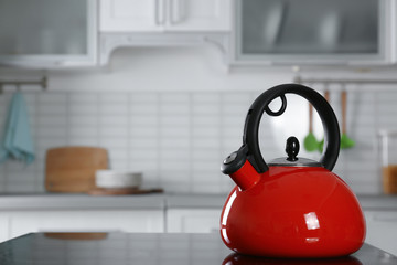 Sticker - Modern kettle with whistle on stove in kitchen, space for text