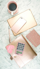 Canvas Print - Feminine desk workspace with rose gold accessories on white marble table, flatlay overhead.