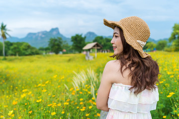 Wall Mural - woman in yellow cosmos flower field