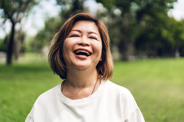 Portrait of happy senior adult elderly asia women smiling and looking at camera in the park.Retirement concept