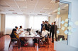 © AS Photo Family - Multiracial business team addressing meeting around boardroom table and write plan on board.