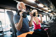 © NDABCREATIVITY - Happy senior people doing exercises in gym to stay fit