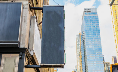 Fototapete - New York, Manhattan. Blank black sign against blur skyscraperscopy space