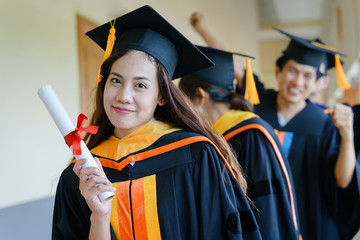 Poster - Female university graduates celebrate happily after completed and received diploma degree. The female graduates express congratulations with each other.