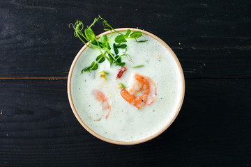 Sticker - Vegetable cream soup with shrimps and croutons in bowl over wooden background with copy space