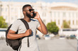 © Prostock-studio - Young african american tourist calling his frients
