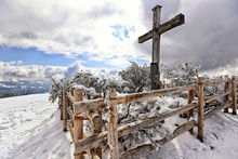 Big Wooden Cross On The Mountain Peak With Wooden Fencing