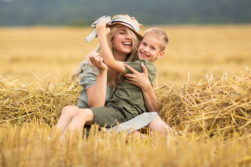 Family photo mom and son playing in the field. Family in the countryside. Family value