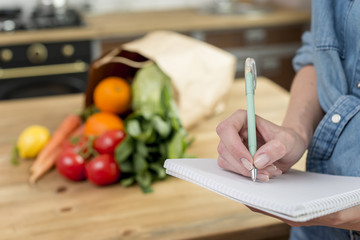 Wall Mural - Person writing a recipe in the notebook