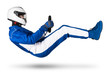 © stockphoto-graf - Race driver with steering wheel in blue white motorsport overall hover over ground in driving seat position with shoes gloves and safety crash helmet, isolated white abstract racing background.