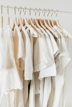 Feminine Clothes On Hanger. Minimal Fashion Composition On White Background. Modern Fashion Blog Concept.