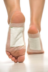 female feet with stickers on white background
