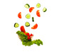 © Julia Kiseleva - fresh vegetables falling into a plate on a white background in slow motion