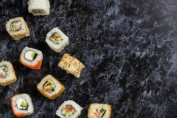 Set of sushi and maki on stone table. Top view with copy space