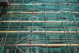 Fototapeta Kwiaty - Professional scaffolding on the side of a building under renovation.