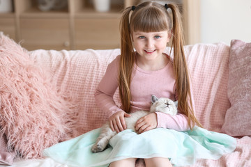 Wall Mural - Girl with cute fluffy kitten at home