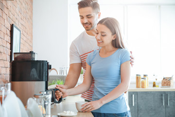 Sticker - Young couple using coffee machine in kitchen