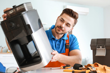 Sticker - Man repairing coffee machine in kitchen