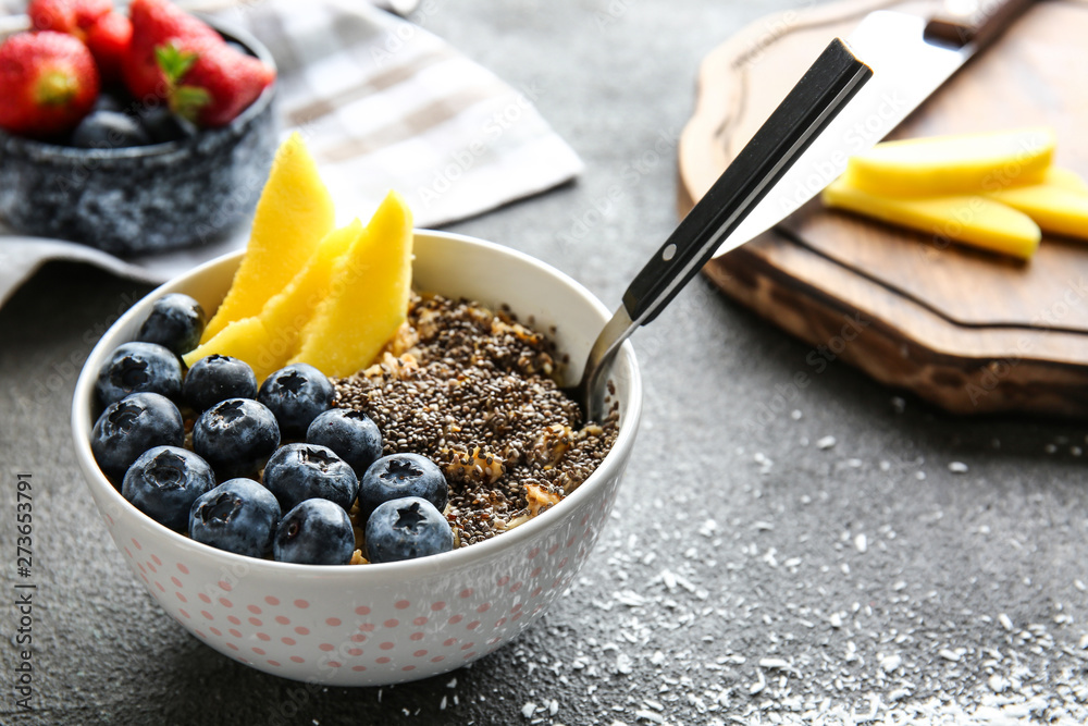 Bowl with tasty chia dessert on dark table