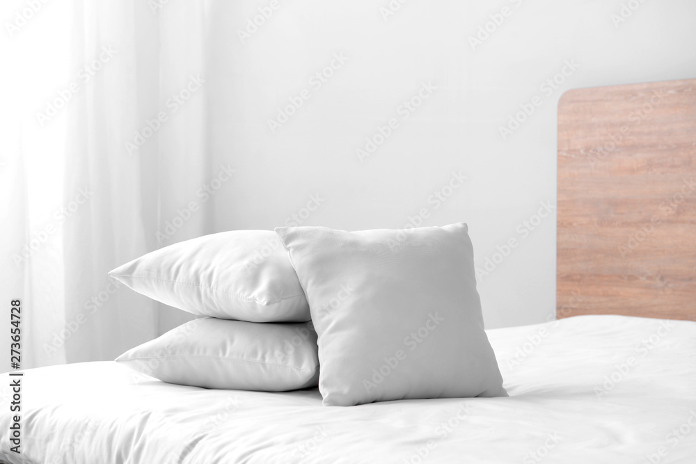 Soft pillows on cozy bed