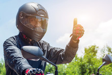 Man In A Motorcycle With Helmet And Gloves Is An Important Protective Clothing For Motorcycling Throttle Control With Sun Light,safety Concept