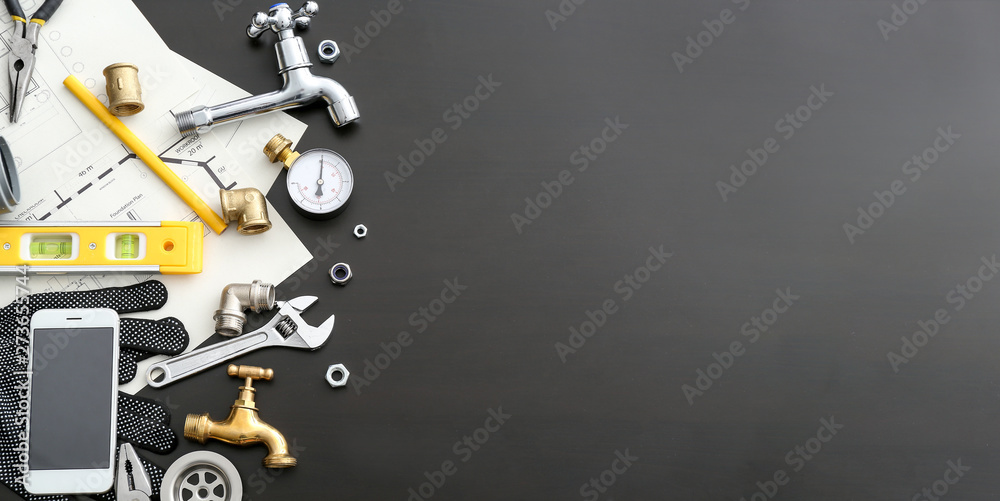 Mobile phone with plumbing items on dark background - obrazy, fototapety, plakaty 