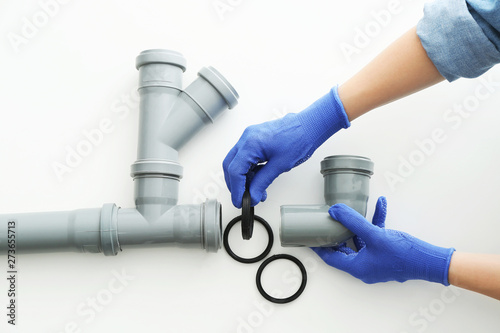 Cuadros en Lienzo Plumber working with drain pipe on white background