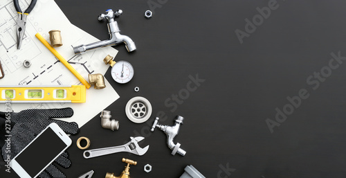 Cuadros en Lienzo Mobile phone with plumbing items on dark background
