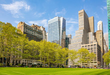Bryant Park, New York, Manhattan. High Buildings View From Below Against Blue Sky Background, Sunny Day In Spring
