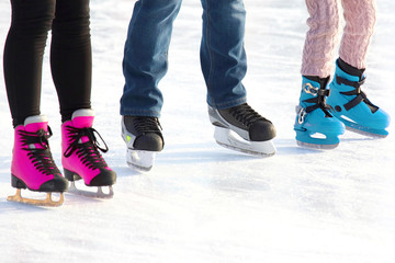 feet of different people skating on the ice rink. sports, Hobbies and recreation of active people.