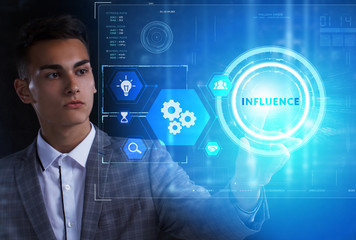 The concept of business, technology, the Internet and the network. A young entrepreneur working on a virtual screen of the future and sees the inscription: Influence