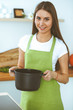 © rogerphoto - Young happy woman cooking soup in the kitchen. Healthy meal, lifestyle and culinary concept. Smiling student girl preparing vegetarian meal at home