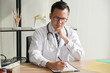 © Anatta_Tan - Portrait images of The doctor is analyzing, And write a report Symptoms of patients at workplace, to health concept.