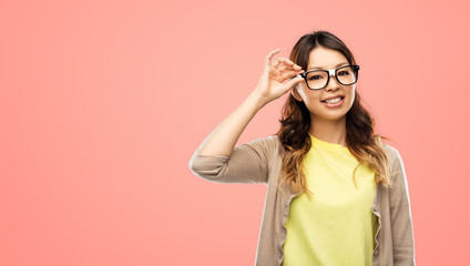 Poster - people, education and school concept - happy asian woman or student in glasses fixed by tape over living coral background