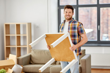 Sticker - moving, people and real estate concept - happy man with table at new home