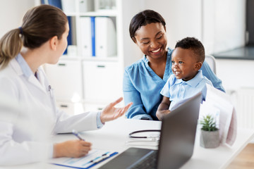 Poster - medicine, healthcare and pediatry concept - happy african american mother with baby son and caucasian doctor at clinic