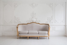 Luxurious Bright Rococo Interior With A Large Sofa And Stucco On The Walls. Selective Focus.