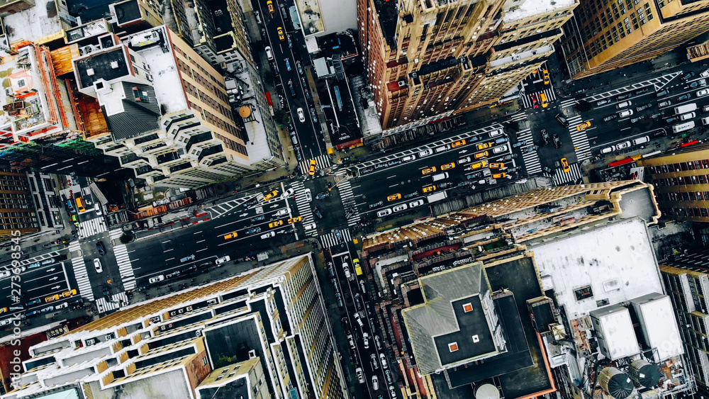 Aerial view of New York downtown building roofs. Bird's eye view from helicopter of cityscape metropolis infrastructure, traffic cars, yellow cabs moving on city streets and crossing district avenues - obrazy, fototapety, plakaty 