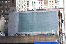 Side Of A Building In New York With Painted-over Advert Space
