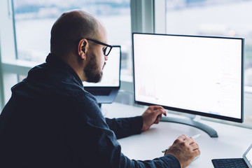 Bearded man working on computer
