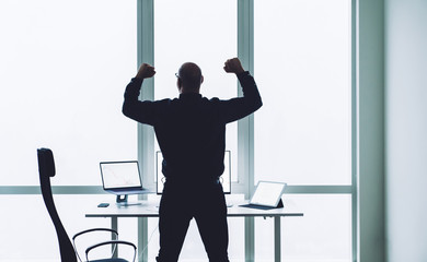 Man celebrating win in office